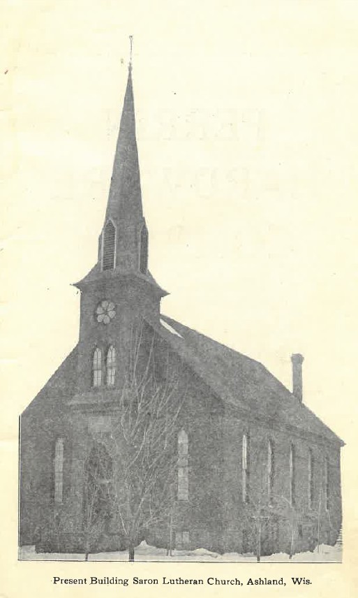 Sepia-toned photo of large church with rose window, stained glass, and tall steeple.