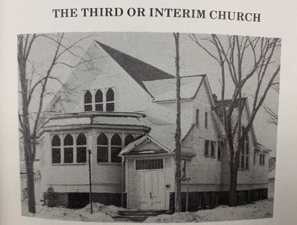 black and white photo of wooden church painted white.